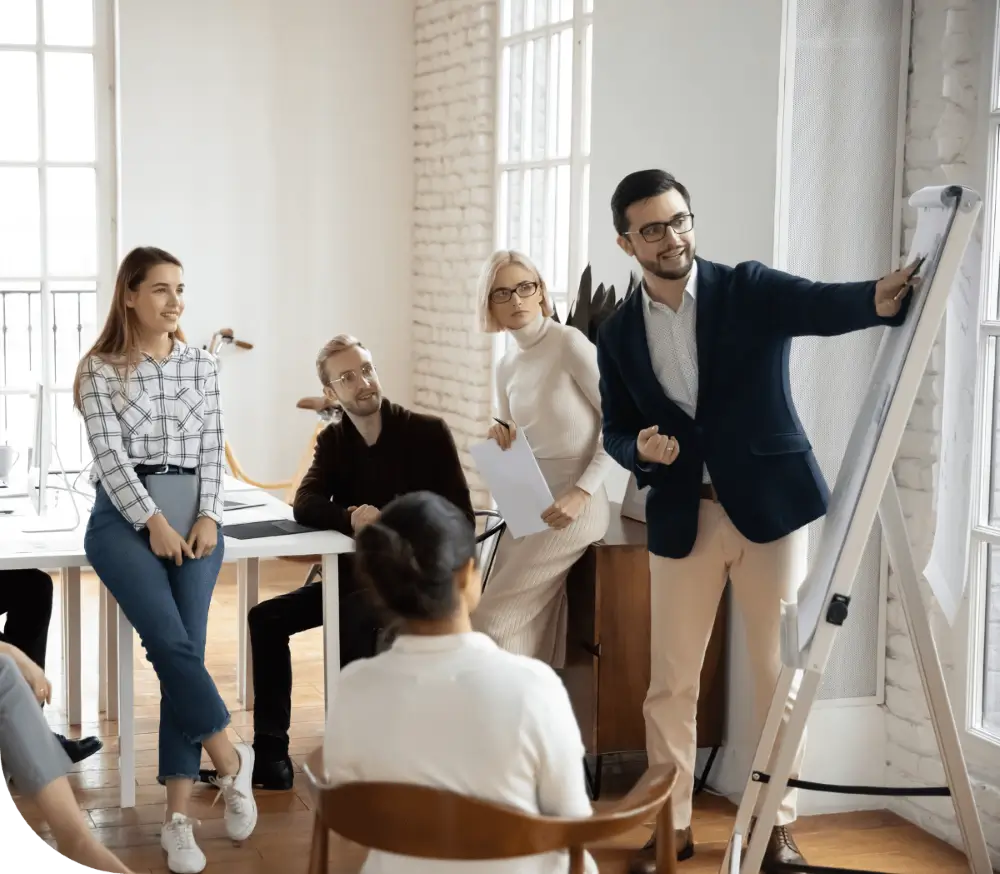 Team discussion around a flip chart.