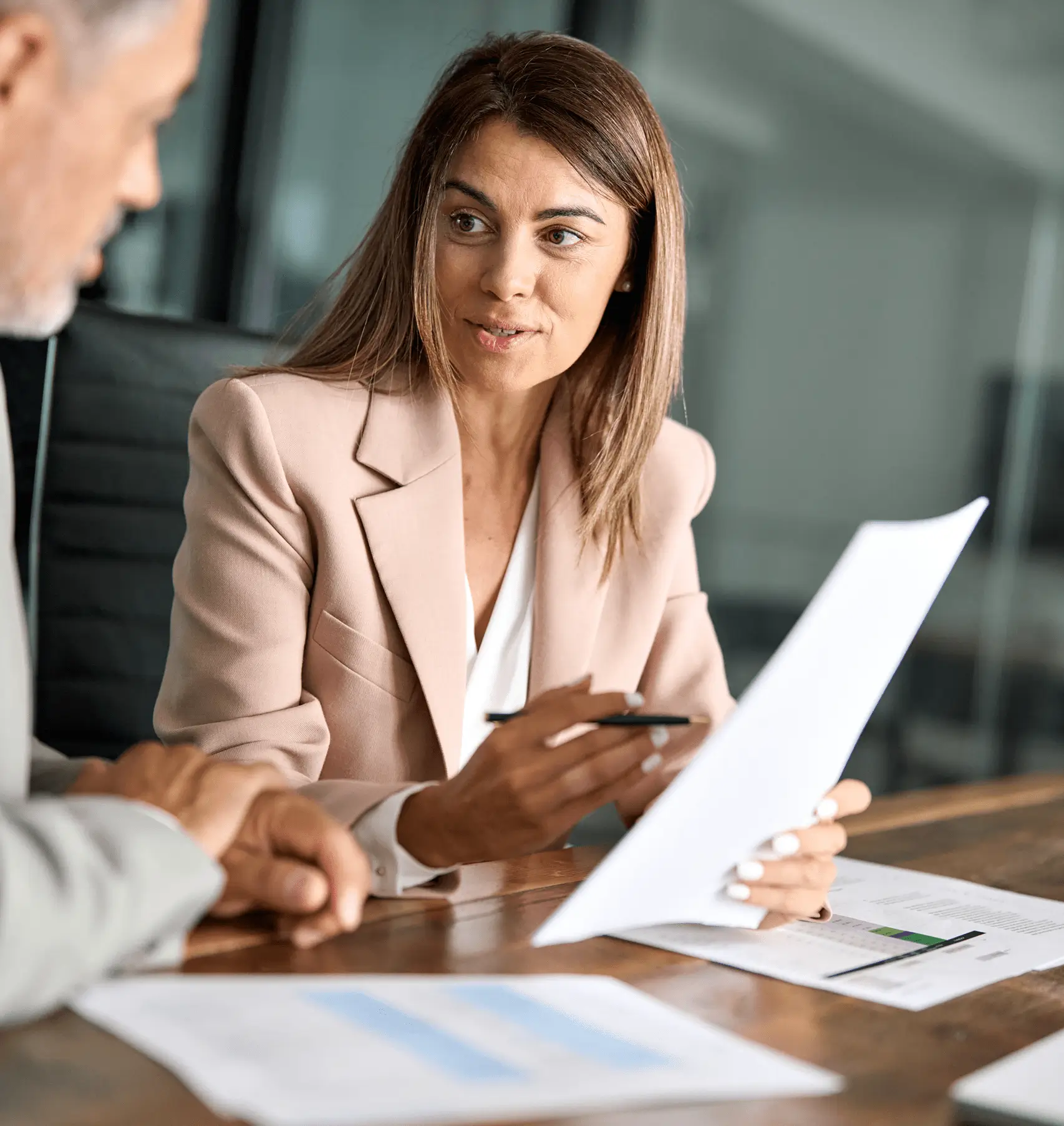 Businesswoman in beige blazer explaining contract